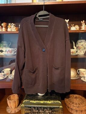 Two cardigans. Black and brown. Faded.